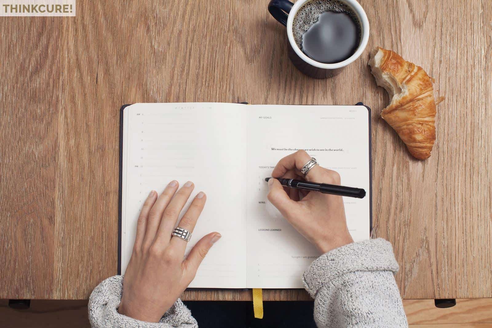 person writing on a book