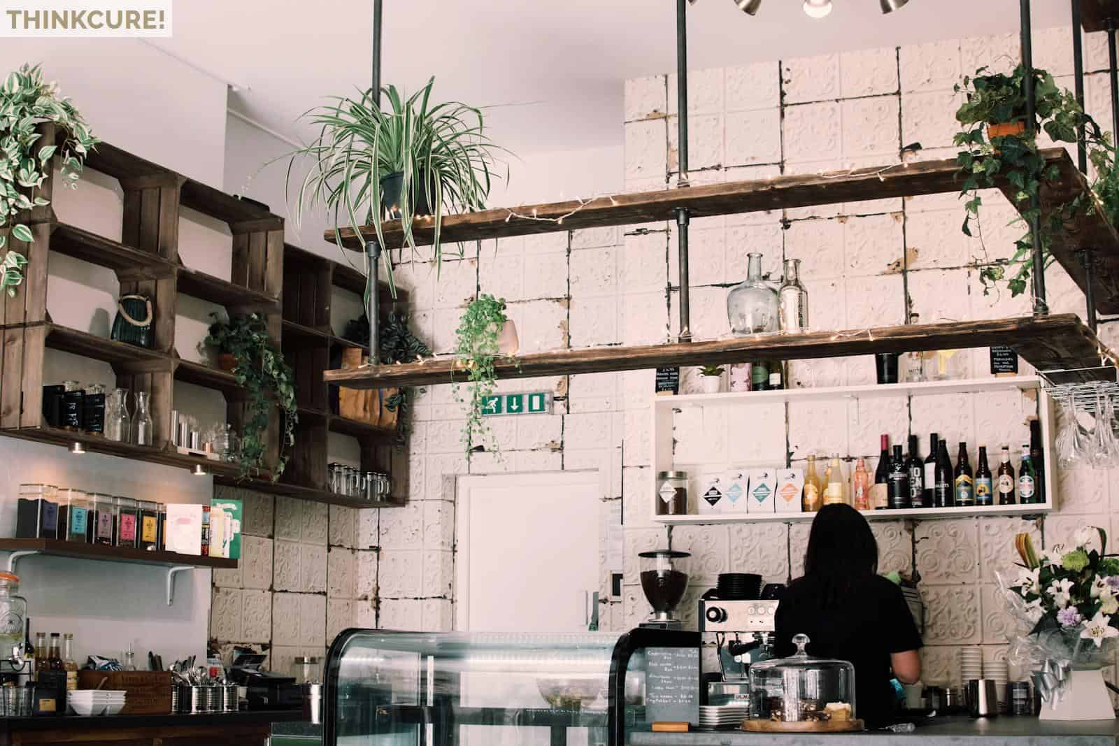 Woman Beside Bottles and Cupboard